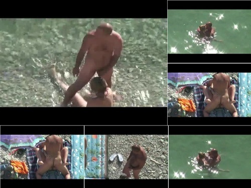 Strangers VoyeursHD com horny couple in the water image