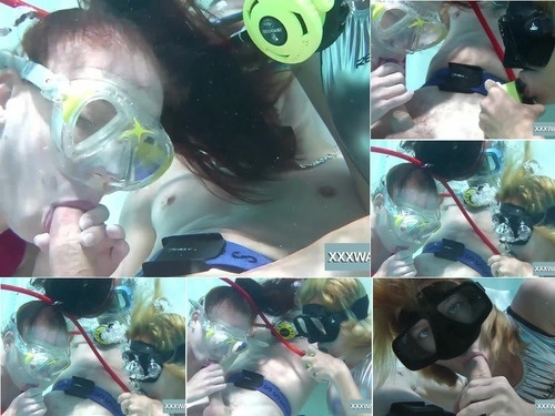 Underwater Two hot girls blow big cock in the pool image