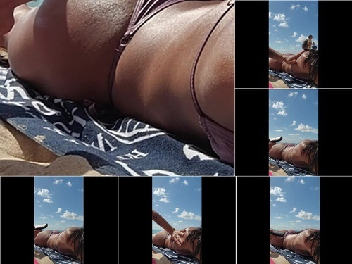 Sara Latina puts suntan lotion on me on the beach image